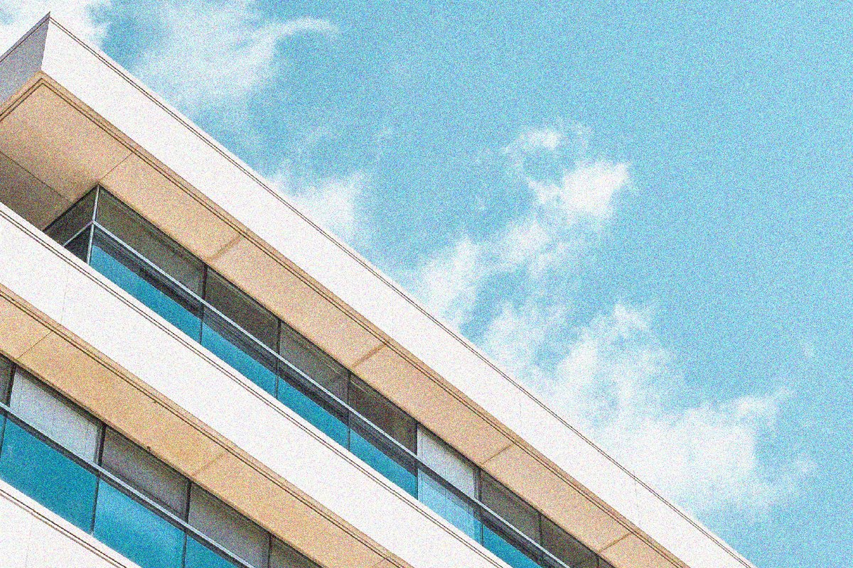 A building against the sky, full of noise